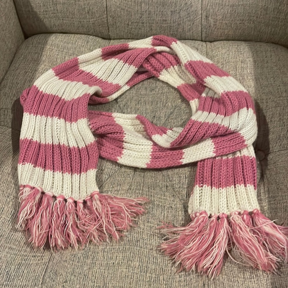Pink and white knit scarf with fringed ends